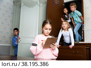 Preteen girl trying to find solution of riddles in quest room. Стоковое фото, фотограф Яков Филимонов / Фотобанк Лори
