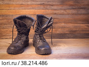 Old leather black male shoes ankle boots on a wooden background front view close-up. Стоковое фото, фотограф Андрей С / Фотобанк Лори