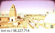 Traditional Arabic architecture in an urban landscape with dramatic sunlight. View of a city El Jem in Tunis, North Africa. Стоковая иллюстрация, иллюстратор Aleksandr Golubev / Фотобанк Лори