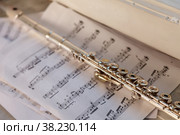 Flute And Sheet Music. Cross flute on a sheet of music. Silver flute on an old musical background. Classical soprano saxophone. Стоковое фото, фотограф Aleksandr Golubev / Фотобанк Лори