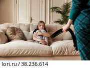Mother wants to punish her child with belt in her hand. Стоковое фото, фотограф Aleksandr Golubev / Фотобанк Лори