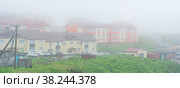 View of the village of Yuzhno-Kurilsk on the island of Kunashir during fog (2022 год). Редакционное фото, фотограф Евгений Харитонов / Фотобанк Лори