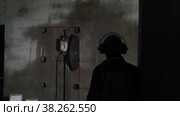 The process of cutting a concrete wall. The operator in special headphones watches the work of the concrete cutter. The round disc cuts concrete. Construction and redevelopment. Стоковое видео, видеограф Дина Дамоцева / Фотобанк Лори