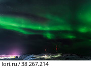 Aurora borealis on the coast of the Barents Sea in the sky over the village of Teriberka, Murmansk region. Russia. Стоковое фото, фотограф Наталья Волкова / Фотобанк Лори