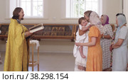 RUSSIA, KAZAN 08-28-2022: priest reads the Bible and conducts a ceremony in front of women in the Orthodox Church. Редакционное видео, видеограф Константин Шишкин / Фотобанк Лори