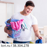 Man doing laundry at home. Стоковое фото, фотограф Elnur / Фотобанк Лори