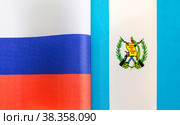 Национальные флаги Российской Федерации и Республики Гватемала крупным планом. Иллюстрация экономических, политических, культурных отношений (2021 год). Стоковое фото, фотограф Лозовая Людмила / Фотобанк Лори