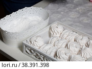 Homemade zephyr. White tray with marshmallows. Nearby is a container of dextrose. For processing marshmallows. Стоковое фото, фотограф Vadzim Yakubovich / Фотобанк Лори