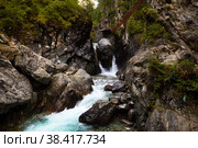 Waterfall on a mountain river. There is a suspension bridge for tourists. Водопад на реке Кыргарга. Стоковое фото, фотограф Виктория Тельминова / Фотобанк Лори