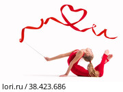 Isolated on white background Girl gymnast in red overalls does exercise with ribbon, the ribbon is twisted into heart. Стоковое фото, фотограф Мария Мороз / Фотобанк Лори