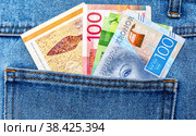 Danish, Norwegian and Swedish kroner protrude from the pocket of jeans. Стоковое фото, фотограф FotograFF / Фотобанк Лори