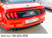 Rear of a Ford Mustang vehicle with car logo and licence plate (2022 год). Редакционное фото, фотограф FotograFF / Фотобанк Лори