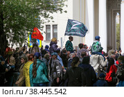 RUSSIA, VOLGOGRAD - May 9, 2022: People carry a flag with the image of the symbol Z and the inscription Support ours! May 9 is Victory Day. Volgograd. Редакционное фото, фотограф Владимир Арсентьев / Фотобанк Лори