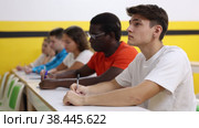 Young man sitting at desk in classroom of school for taxi drivers. Стоковое видео, видеограф Яков Филимонов / Фотобанк Лори