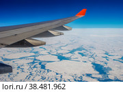 The wing of the aircraft over the Arctic ocean. Стоковое фото, фотограф Игорь Кляхин / Фотобанк Лори