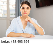 Upset young woman sitting at table. Стоковое фото, фотограф Яков Филимонов / Фотобанк Лори
