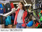 Smiling young girl chose skis, shelm and boots. Стоковое фото, фотограф Яков Филимонов / Фотобанк Лори