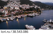 View from drone of small Turkish town of Kas on Turquoise Coast of Aegean Sea overlooking embankment and marina. Стоковое видео, видеограф Яков Филимонов / Фотобанк Лори
