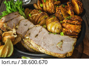 Slices of sliced sliced baked pork tenderloin with fried spiral potatoes. Стоковое фото, фотограф Оксана Медведева / Фотобанк Лори
