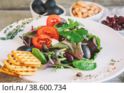 Salad diet for weight correction from the leaves of Lollo Rosso lettuce, watercress salad and other green herbs with tomatoes, olives and fitaki. Стоковое фото, фотограф Оксана Медведева / Фотобанк Лори