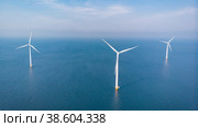 Wind turbine aerial view, Drone view at windpark westermeerdijk a windmill farm in the lake IJsselmeer. Стоковое фото, фотограф Fokke Baarssen / Фотобанк Лори