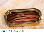 Close-up of canned anchovy fillet in oil on wooden surface. Стоковое фото, фотограф Яков Филимонов / Фотобанк Лори