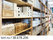 Supermarket of household goods - wooden original caskets on shelves. Стоковое фото, фотограф Яков Филимонов / Фотобанк Лори