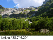 Concept of great nature mountain range. Amazing view of caucasus mount and Sofia waterfalls landscape, green forest, path to peak and blue cloudy sky as background at sunny summer day. Russia, Arkhyz. Стоковое фото, фотограф Евгений / Фотобанк Лори