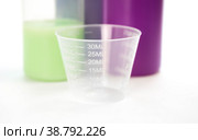 A small transparent measuring Cup. Close up. Isolated on a white background. Стоковое фото, фотограф Плотников Дмитрий / Фотобанк Лори