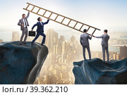 Business people helping to go over chasm. Стоковое фото, фотограф Elnur / Фотобанк Лори