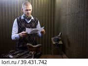 Man looking at paper target checking target hit at firing range. Стоковое фото, фотограф Яков Филимонов / Фотобанк Лори