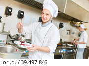 cook chef preparing food in restaurant kitchen. Стоковое фото, фотограф Дмитрий Калиновский / Фотобанк Лори