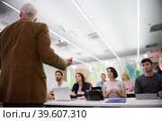 teacher with a group of students in classroom. Стоковое фото, фотограф Benis Arapovic / PantherMedia / Фотобанк Лори