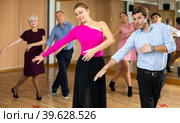 Woman and man practicing vigorous jitterbug in dance class. Стоковое фото, фотограф Яков Филимонов / Фотобанк Лори
