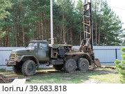 Drilling rig on zil car are drilling artesian well for water in ground. Insertion of metal casing pipe into ground, installation of individual drinking supply. Стоковое фото, фотограф Ольга Симонова / Фотобанк Лори
