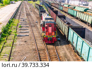 Shunting diesel locomotive and railway wagons. Railway wagons at the station for the transportation of goods. Rails at the railway station. The movement of the train at the marshalling yard. Стоковое фото, фотограф Эдуард Белкин / Фотобанк Лори