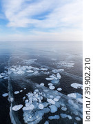 Beautiful winter landscape of frozen Baikal Lake in cold February day. Endless ice fields with white cracks and bubbles. Natural seasonal background. Winter ice travel and active outdoors. Стоковое фото, фотограф Виктория Катьянова / Фотобанк Лори