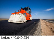 Kyzylorda province, Kazakhstan, April 29, 2012: Construction of West Europe-West China road. Hamm asphalt compactor on new asphalt layers. Стоковое фото, фотограф Alexey Rezvykh / Фотобанк Лори