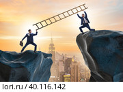 Business people helping to go over chasm. Стоковое фото, фотограф Elnur / Фотобанк Лори