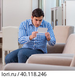 Young man shopping in furniture store. Стоковое фото, фотограф Elnur / Фотобанк Лори