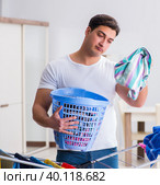 Man doing laundry at home. Стоковое фото, фотограф Elnur / Фотобанк Лори
