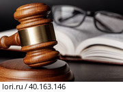 Wooden gavel and juridical books close up. Стоковое фото, фотограф Сергей Толмачёв / Фотобанк Лори