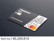 Tinkoff Bank plastic credit debit card close-up on black background. krasnoyarsk, russia, 2022 09 26. Редакционное фото, фотограф Владимир Разгуляев / Фотобанк Лори