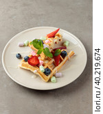 Sweet Belgian waffle with berries and marshmallows. Close-up, isolate. Стоковое фото, фотограф Bogdanova Mariia / Фотобанк Лори
