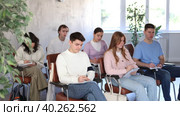Group of concerned undergraduates listening to lecture and making notes attentively in auditorium. Стоковое видео, видеограф Яков Филимонов / Фотобанк Лори