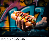 A big juicy hot dog in the style of graffiti. Стоковое AI-изображение, AI-художник Ярославский Максим / Фотобанк Лори