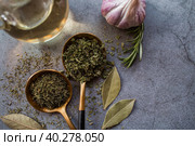 Fragrant spices. Dried parsley, dill, rosemary, garlic, and bay leaf on a gray background. Free space. Стоковое фото, фотограф Photojuli / Фотобанк Лори