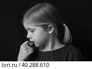 Listen to your heart. Thinkful and little unsettling small girl holding heart shaped object. Black and white portrait. AI generative image. Стоковое AI-изображение, AI-художник Сергей Старуш / Фотобанк Лори