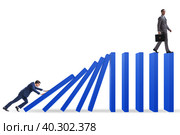 Businessman in domino effect concept. Стоковое фото, фотограф Elnur / Фотобанк Лори