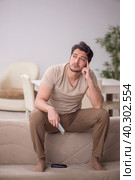 Young man watching tv at home. Стоковое фото, фотограф Elnur / Фотобанк Лори